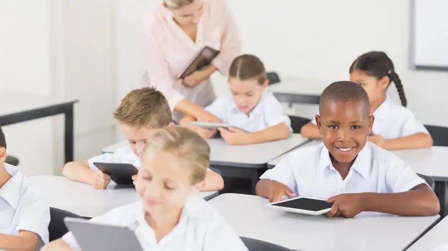 Children using tablets in class